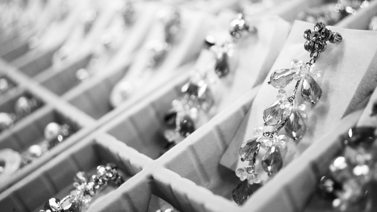 Close-up of elegant crystal earrings in a display box highlighting intricate jewelry details.